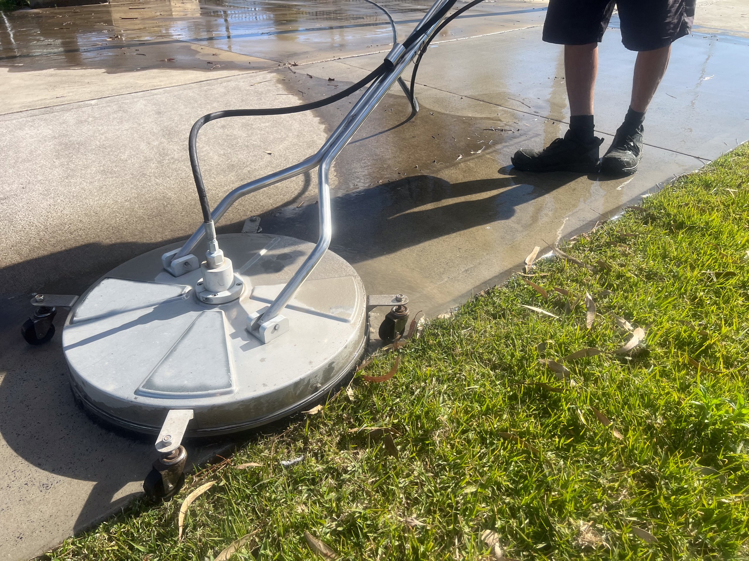 Sidewalk before and after pressure washing showing dramatic clean results